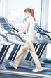 Young woman at the gym exercising. Running