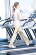 Young woman at the gym exercising. Running