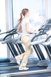 Young woman at the gym exercising. Running
