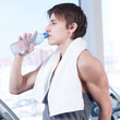 man at the gym drinking water
