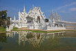 Castle beautifully reflected in a pond with live fish