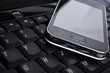 Cell phone on laptop keyboard