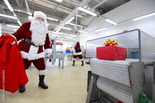 Photo: santa claus waiting for present in factory santa claus waiting for present in factory
