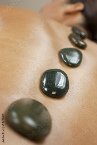Photo: Woman Relaxing At Health Spa Having Hot Stone Treatment Massage Woman Relaxing At Health Spa Having Hot Stone Treatment Massage