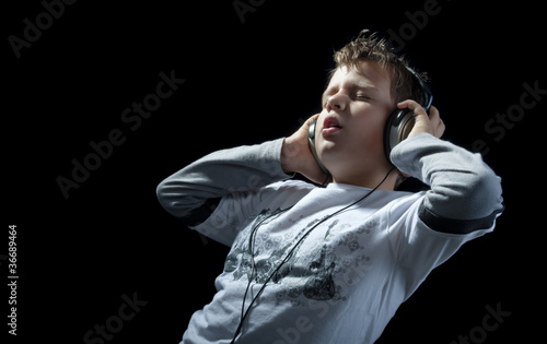 Photo: kid with earphones on black kid with earphones on black