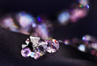 Diamond (small purple jewel) stones heap over black silk cloth b