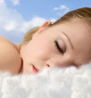 Portrait of a young girl sleeping  with  clouds
