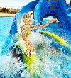 Child on water slide at aquapark.