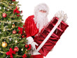 Santa Claus by christmas tree carrying stack gift box.