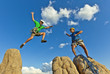 Rock climbing team reaching the summit.