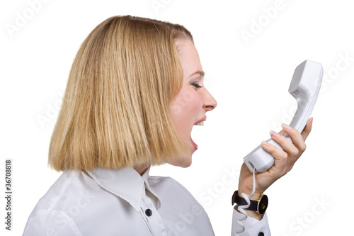Photo: Business woman shouting into the telephone receiver Business woman shouting into the telephone receiver