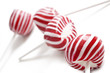Colorful red lollipops on white background