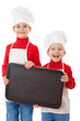 Smiling little cookers with empty chalkboard
