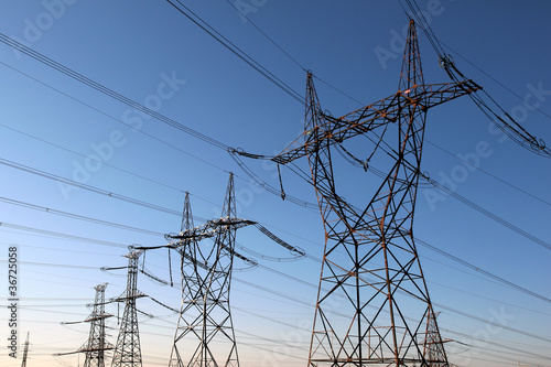 Photo: high voltage electrical towers in line high voltage electrical towers in line