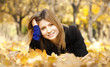 Smiling happy girl in autumn park