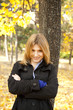 Smiling happy girl in autumn park