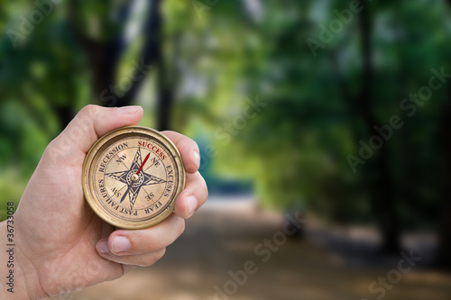 Photo: Male Hand Holding Success Compass Male Hand Holding Success Compass