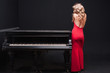 Foto: beautiful young attractive woman in cocktail dress and piano beautiful young attractive woman in cocktail dress and piano