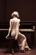 Foto: beautiful young attractive woman in cocktail dress and piano beautiful young attractive woman in cocktail dress and piano