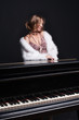 Foto: beautiful young attractive woman in cocktail dress and piano beautiful young attractive woman in cocktail dress and piano