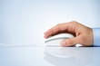 Male hand holding computer mouse with copy space