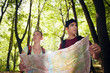 young couple looking at map during trek
