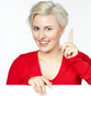 Beautiful blonde lady shows copyspace on white background