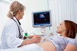 Pregnant woman getting ultrasound diagnostic from doctor