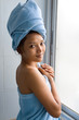 Foto: Young woman wrapped towel in bathroom Young woman wrapped towel in bathroom