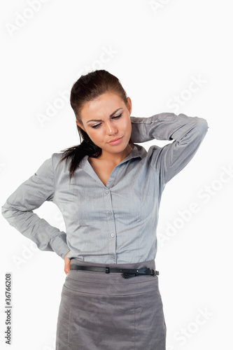 Photo: Portrait of a depressed businesswoman having back pain Portrait of a depressed businesswoman having back pain