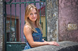 A pretty young woman walking on a colorful, narrow cobblestone s
