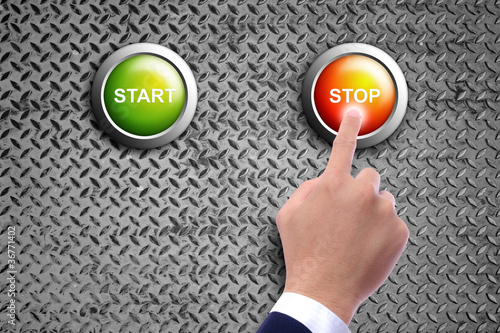 Photo: hand pushing stop button on diamond steel background hand pushing stop button on diamond steel background