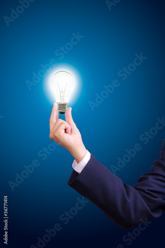 Photo: hand holding light bulb hand holding light bulb