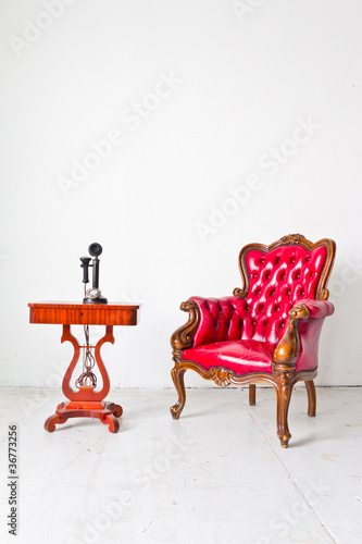 Photo: vintage luxury armchair and telephone in white room vintage luxury armchair and telephone in white room
