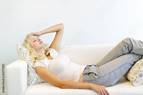 Photo: Tired woman laying on couch Tired woman laying on couch