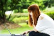a beautiful girl using laptop at outdoor