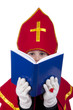 Boy playing Dutch Santa Claus Sinterklaas with book