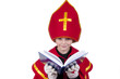 Photo: Boy playing Dutch Santa Claus Sinterklaas with book Boy playing Dutch Santa Claus Sinterklaas with book