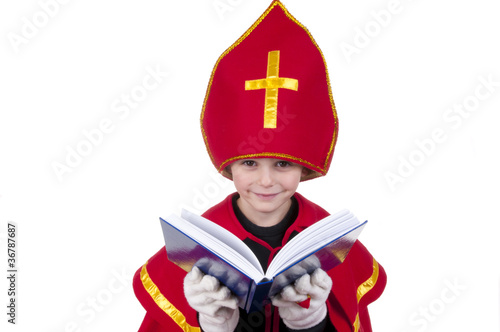 Photo: Boy playing Dutch Santa Claus Sinterklaas with book Boy playing Dutch Santa Claus Sinterklaas with book
