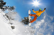 Snowboarder jumping against blue sky