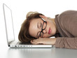Young business woman sleeping on her laptop at work
