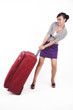 Beautiful Asian woman with heavy suitcase