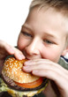 Young boy eating cheeseburger