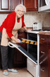 senior woman baking cookies