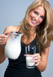 Young woman pour out milk into glass Young woman pour out milk into glass
