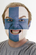 Face of crazy angry man painted in colors of finland flag