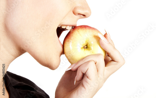 Photo: Young woman eating apple Young woman eating apple