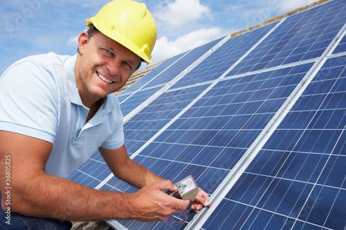 Photo: Man installing solar panels Man installing solar panels