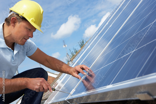 Photo: Man installing solar panels Man installing solar panels