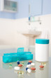 Pills and organiser in bathroom